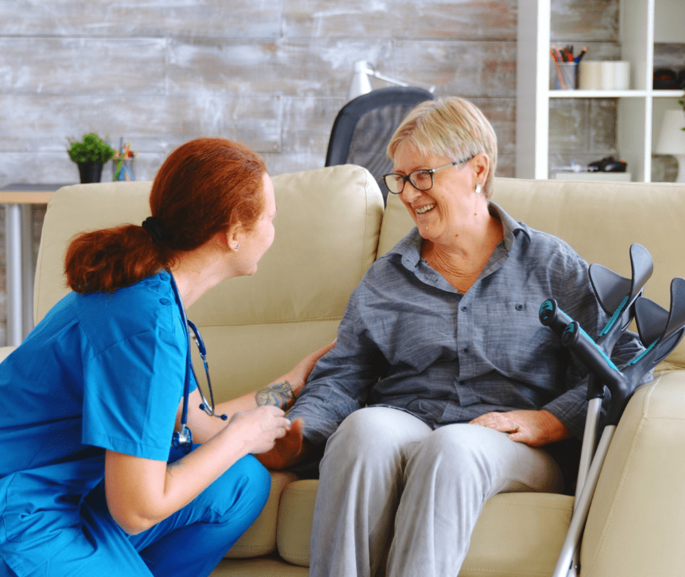 female nurse talking with old woman with alzheimer in nursing home