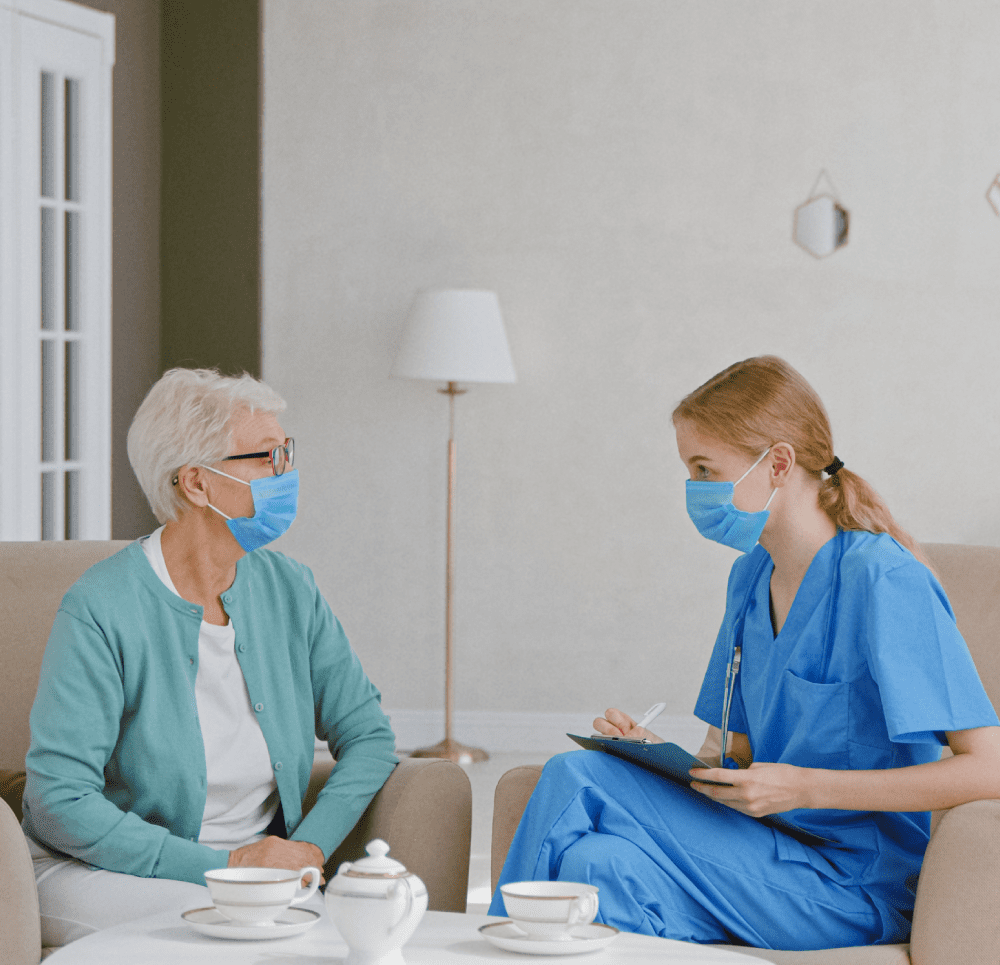 nurse and old women having conversation